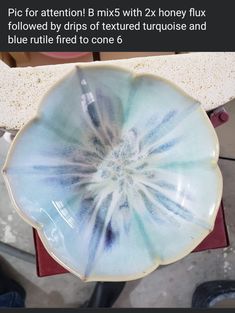 a blue and white bowl sitting on top of a table