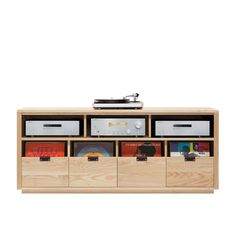 a wooden entertainment center with drawers and an audio player