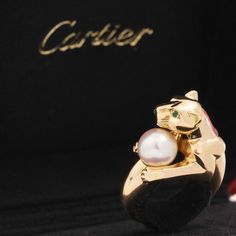 Tres chic ring from Cartier from their Vedra collection, now discontinued and highly collectible. The ring showcases their iconic panther, clutching a pearl. A wonderful juxtaposition showcasing power and femineity at the same time. 18kt yellow gold Stamped Cartier and numbered Size 52 (fits like a size 6) Will come with paperwork from Cartier New York where the ring was recently sent for refurbishment. Please see qualitative report for more information. Video Below Luxury Pearl Ring For Evening, Modern Mens Rings, Art Jewelry Earrings, Chic Rings, All Band, Antique Watches, Antique Engagement, Mens Band, Vintage Band