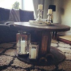 a living room table with two candles on it