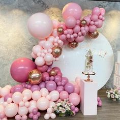 there are balloons and other decorations on the floor next to a table with flowers in it