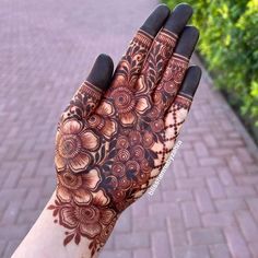 a woman's hand with henna on it