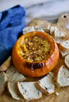 an orange bowl filled with food sitting on top of bread