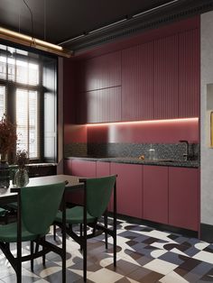 a kitchen with checkered flooring and pink cabinets, black counter tops and green chairs