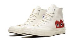 The Comme des Garcons Play x Converse Chuck 70 Hi “White” is a popular collaborative version of the classic sneaker by the world-renowned fashion house.  The CDG makeover of the Chuck Taylor has a ‘Milk’ white upper with their Play imprint’s signature heart with eyes graphic peeking up from the midsole and the heel.  The classic All Star logos are found on each medial ankle, while a black canvas panel adds contrast to the heels.  A solid white sole unit finishes off the clean unisex Comme des Ga Converse Cdg, Play X Converse, Baskets Converse, Nike X Travis Scott, Converse Run Star, Converse Chuck 70, Jordan 2, Comme Des Garcons Play, Air Huarache