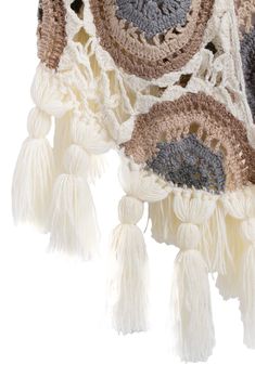 An eye-catching crochet construction adds handcrafted texture to a layer-ready shawl trimmed with tassels. 100% acrylic Hand wash, line dry Imported Bohemian White Shawl With Tassels, White Bohemian Poncho With Fringe, White Crochet Shawl For The Beach, Bohemian Cream Poncho With Fringe, White Bohemian Shawl With Tassels, Handmade Bohemian Cream Shawl, Beige Bohemian Shawl With Intricate Embroidery, Luxury Cream Bohemian Shawl, Bohemian Cream Shawl With Fringe