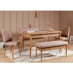 a wooden table with two chairs and a bench in front of it on top of a rug