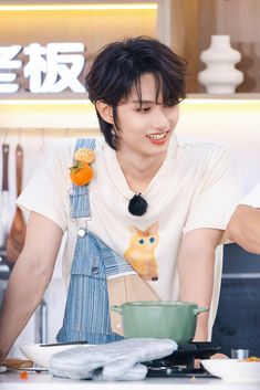 a young man is preparing food in the kitchen