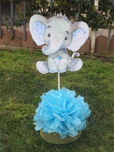 an elephant centerpiece on top of a cake in the grass