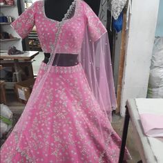 Brand New Custom Designed Hot Pink Lehenga In Raw Silk Material With Beautiful Silver Hand Embroidery With Zardosi And Aari Work By Indian Artisans. Silver Raw Silk Sets With Zari Work, Silver Zari Work Raw Silk Sets, Silver Designer Sets With Intricate Embroidery, Silver Sets With Intricate Embroidery For Designer Wear, Silver Anarkali Set In Raw Silk, Anarkali Silver Raw Silk Set, Anarkali Style Silver Raw Silk Set, Silver Traditional Wear With Cutdana For Reception, Silver Cutdana Traditional Wear For Reception