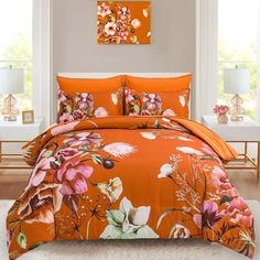 a bed with orange and pink flowers on it