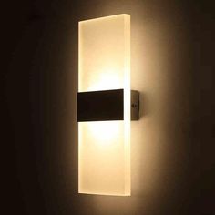 an illuminated wall light in a dark room