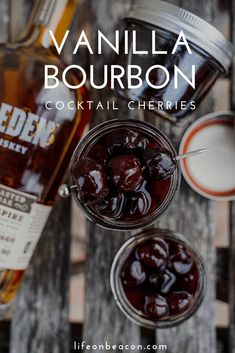 vanilla bourbon cocktail with ice and cherries in mason jars on a wooden table top