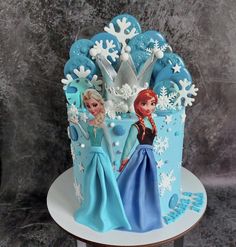 a frozen princess birthday cake with blue frosting