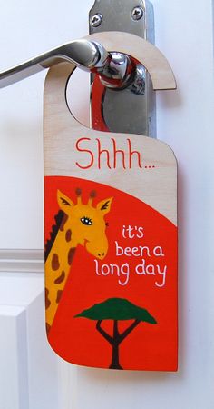 a door hanger with a giraffe on it