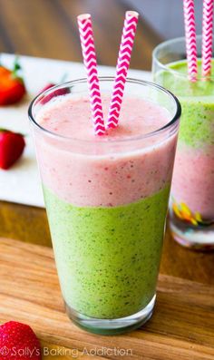 two glasses filled with smoothie and strawberries