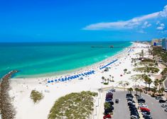 an aerial view of a beach with cars parked on it