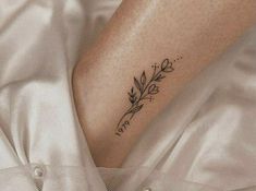 a woman's foot with a small tattoo on her left leg and the word love written