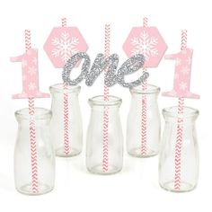 pink and silver snowflake number one candle holders with striped straws in them