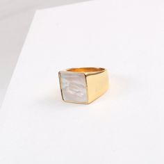 This 18K Gold Plated Large Square Mother-of-Pearl Ring is a luxurious, statement-making piece. Featuring a chunky gold band with both mother-of-pearl and black onyx accents, it's the perfect unique gift for any special occasion. This signet ring is also an ideal stacking ring for daily wear. [MATERIAL]: Yellow brass with real 18k gold plated. Our ring will not tarnish or turn green.[PLEASE NOTE]: Each shell color is unique so the shade and color might slightly vary. Elegant Gold Rings With Mother Of Pearl, Gold Mother Of Pearl Rings For Anniversary, Gold Mother Of Pearl Anniversary Rings, Gold Mother Of Pearl Ring For Gift, Gold Mother Of Pearl Ring As A Gift, Modern Gold Jewelry With Mother Of Pearl, Mother Of Pearl Ring, Clean Sterling Silver, Shell Color