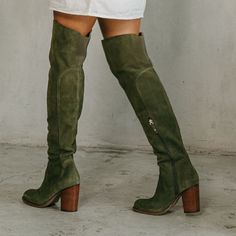 Our best-selling thigh-high boot will elevate any ensemble. The Logan olive over-the-knee boot features a soft, unlined suede upper, an easy to wear heel height, and an elastic back panel at the calf for added comfort. Suede upper in olive Insole: Canvas Lining material: Vamp, canvas and shaft unlined Outsole: Recycled rubber Style type: Over the knee boot Heel material: Stacked Heel height: 3.15 inches Shaft height: 20 inches Calf circumference: 14 inches Brass functional inside zipper Elastic Taupe Knee High Boots Outfit, Tall Ugg Boots Outfit, Brown Suede Boots Outfit, Green Thigh High Boots, Suede Boots Outfit, Womens Fall Boots, Boot Outfits, Work Fits, Brown Knee High Boots