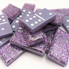 purple dices with white dots on them are scattered over the top of each other