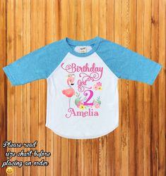 "Flamingo birthday shirt, flamingo family shirts, birthday girl flamingo shirt, first birthday outfit, baby girl birthday, baby girl H234 Wellcome to happy kid Customs!! : ) Please read all info before placing your order : ) This Design IS NOT MADE with glitter. -This listing is for a 3/4 colored sleeve/white body OR White short sleeve personalized shirt, we carry different sizes. ( Please make sure to select the same type of shirt you are purchasing on both drop down menus if you select a short Long Sleeve Summer Tops For Birthday, Pink Birthday Shirt For Summer, Pink Summer Birthday Shirt, Long Sleeve Summer Shirt For Birthday, Playful Pink Top For First Birthday, Playful Pink Tops For First Birthday, Pink T-shirt For Birthday In Summer, Pink Summer Tops For Birthday, Pink Summer T-shirt For Birthday