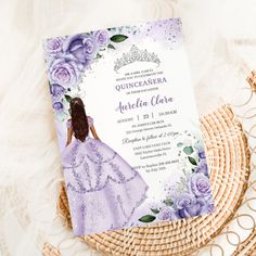 a purple princess birthday party with flowers on the table and a card in front of it