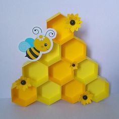 a yellow honeycomb with bees and flowers on the top is cut out to look like hexagons