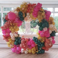 a wreath made out of balloons and flowers