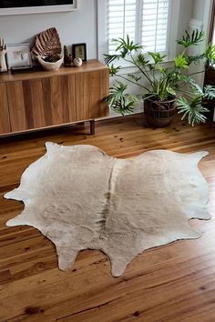 a cow hide rug on the floor in a living room