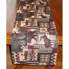 a table runner made out of quilts on top of a wooden table next to a chair