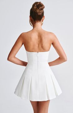 This mini IS the moment. Cut from our premium crepe fabric, Bryony has a strapless neckline and is fitted through the bust and waist for a super flattering fit. It flares gently at the skirt with box pleat detailing. Pair with cute loafers for daytime chic or heeled mules and minimal jewellery to dress her up. 



Colour: Ivory.

Premium non-stretch crepe.

Fully lined.

Strapless neckline.

Fitted on bust and waist.

Panelled seam detail.

Box pleat skirt.

Invisible zipper to back.

Mini lengt Cute Loafers, Homecoming Dresses Corset, White Dress Spring, Midi Dress Wedding Guest, Minimal Jewellery, Box Pleat Skirt, Pleat Skirt, Maxi Dress Sale, Strapless Neckline