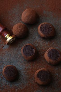 chocolate truffles with initials on them and a bottle of wine