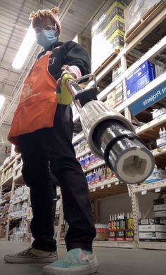 a man in an orange safety vest is using a grinder