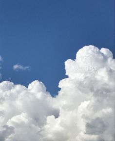 the plane is flying high in the blue sky with white clouds behind it and an airplane on the right side