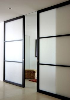 an empty room with sliding glass doors on the wall and carpeted flooring in front of it