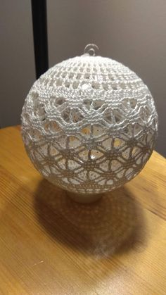 a white ball sitting on top of a wooden table