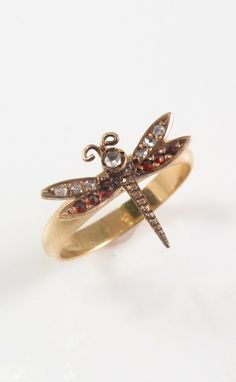 Offering this splendid feminine petite 10k rose gold Victorian dragonfly diamond & garnet insect ring. This ring was repurposed from an antique 10k rose gold pin, and the head was welded by our jeweler to a modern 10k yellow gold ring shank.  Ring is a size 6.25 and has a total weight of 2.3 Grams. Dragonfly portion of ring is 1/2"L by 5/8"W and is unmarked but tested as 10K. Ring is presented in very good overall condition with normal wear for age. (See magnified photos). Thanks for viewing, please check out our other auctions. Total Weight: Approximately 2.3 Grams Dragonfly is 1/2"L x 5/8"W Hallmarked 10K Ring, Unmarked Tested 10K Dragonfly Victorian Era Dragonfly Approximate Ring Size: 6.25 Dragonfly Jewelry Rings, Insect Ring, Dragonfly Ring, Antique Jewelry Rings, Ring Shank, Gold Pin, Yellow Gold Ring, Victorian Era, 10k Gold