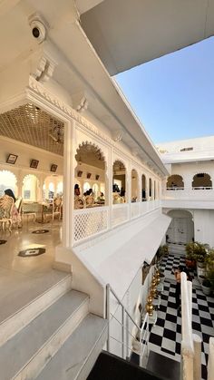 the inside of a white building with black and white checkered flooring on it