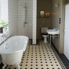 a white bath tub sitting in a bathroom next to a sink