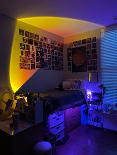 a bedroom with purple lighting and pictures on the wall above it, along with a bed