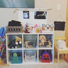 a room filled with lots of toys and stuffed animals on top of white shelving units