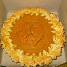 there is a pie in the box that has been made to look like an orange