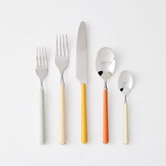 four forks, two spoons and one knife on a white surface with different colors