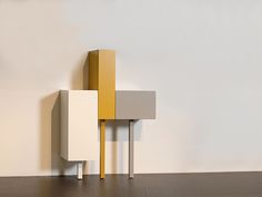 a white and yellow cabinet sitting on top of a floor