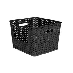 a black basket with white dots on the sides and handles, sitting against a white background