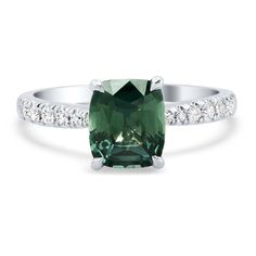 an oval cut green tourmaline ring with diamonds on the sides and side stones