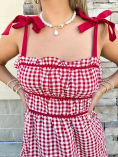 The Tailgate Cutie Gingham Dress: a mini dress perfect for game day! With its playful gingham print and adjustable straps, you'll be the cutest fan in the stadium. So why not treat yourself to this stylish and comfortable dress? Game day just got a whole lot cuter! Adjustable straps Solid trim Cute Gingham Plaid Dress For Day Out, Trendy Gingham Dress For Picnic, Gingham Dress With Tie Straps For Picnic, Gingham Dress With Tie Straps For Day Out, Red Gingham Dress, Vintage Gingham, Crystal Dress, Casual Work Wear, Pink Pineapple