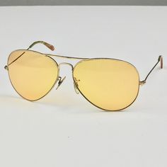 !950's Ray Ban Shooter, gold frame, bright yellow lens, Circa 1950's. BRIGHT yellow lens I think they called these Kalichrome. Feel free to ask me with any questions! sunglasses and case are in good vintage condition, light wear from storage to be expected and some pitting on the top of frame. Please ask questions before purchasing, all sales are final. Retro Gold Sunglasses With Uv Protection, Gold Retro Sunglasses With Uv Protection, Retro Gold Sunglasses With Mirrored Lenses, Gold Retro Sunglasses With Mirrored Lenses, Vintage Gold Sunglasses With Gradient Lenses, Retro Gold Aviator Sunglasses With Mirrored Lenses, Retro Gold Aviator Sunglasses With Gradient Lenses, Gold Retro Aviator Sunglasses With Gradient Lenses, Vintage Yellow Polarized Sunglasses